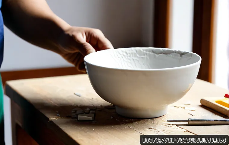 도자기 복원 및 수리법 - Photorealistic close-up of a skilled craftsperson repairing a cracked white ceramic bowl on a clean ...